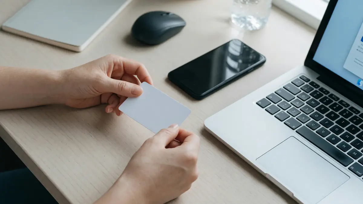 Neutral fintech desk with card and verification checklist